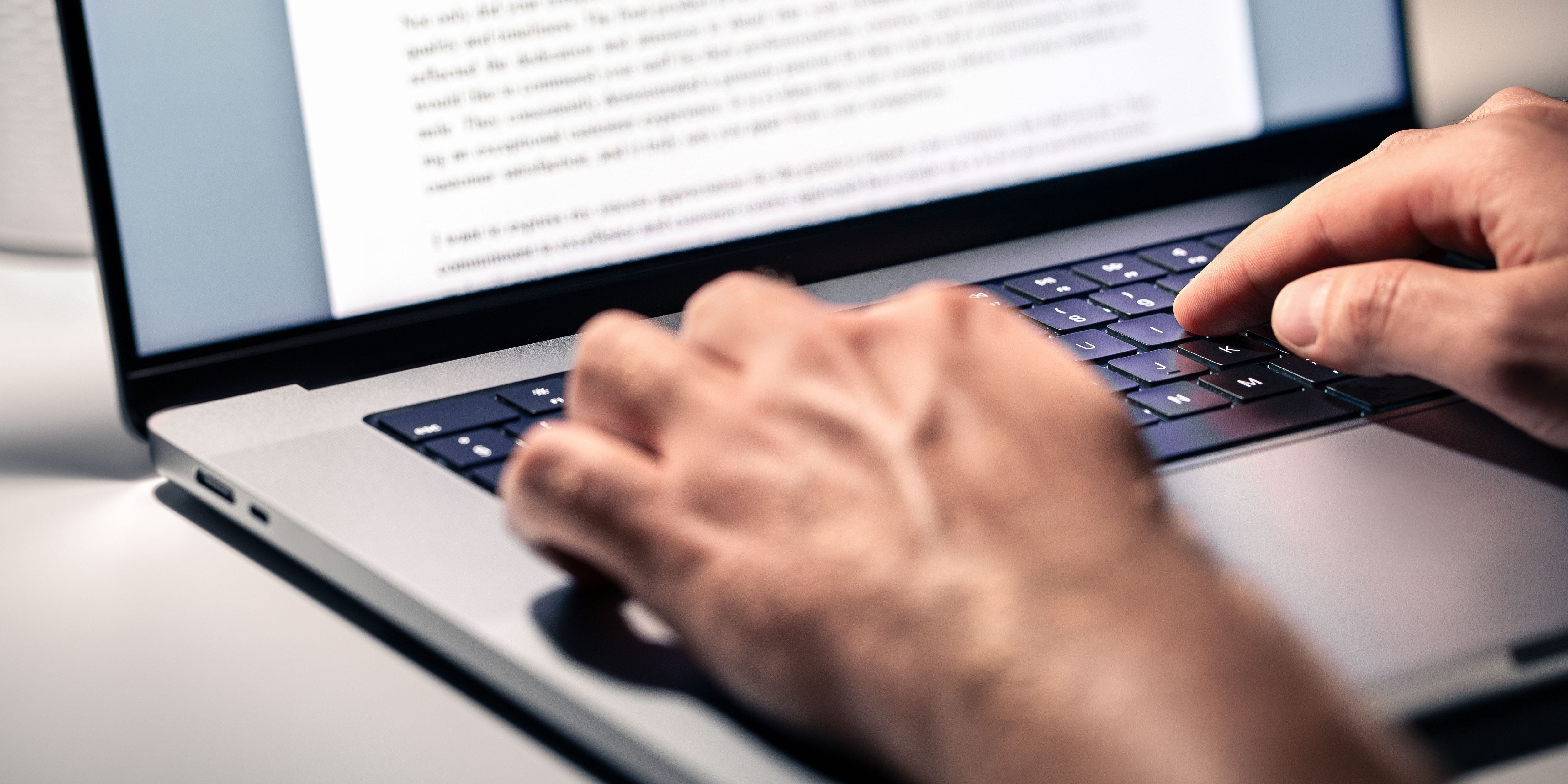 A man typing on a laptop