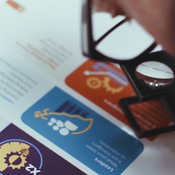 a man closely inspecting a print piece