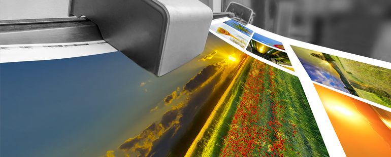 Close-up of a digital printer printing high-resolution colorful landscape photos