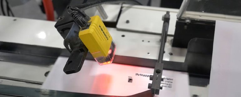 Barcode scanner reading a printed label on a mailing line  Let me know if you’d like a variation!