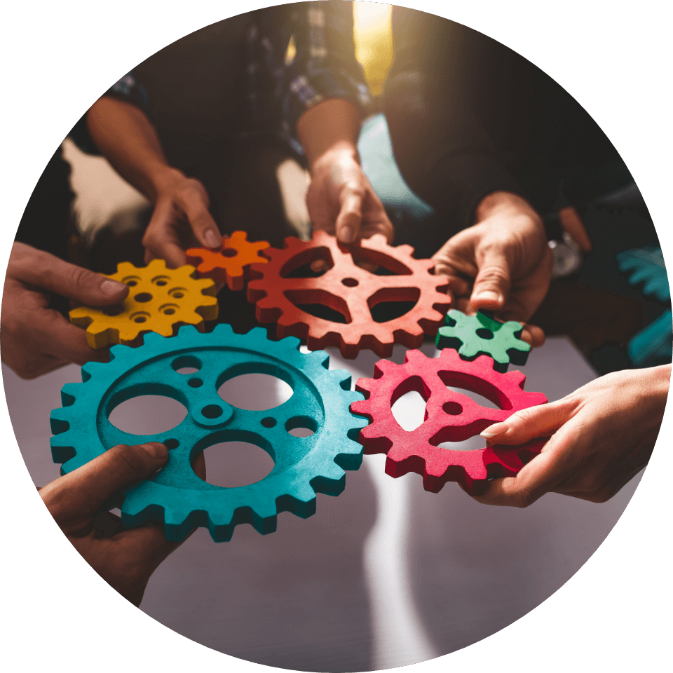 Hands connecting colorful gear pieces in a teamwork concept